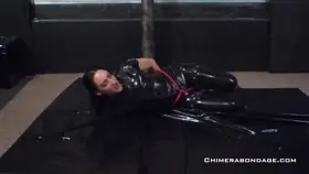 Latex Doll Struggling In Bondage